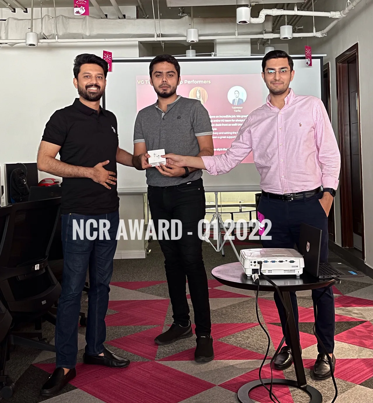 Taimour Tariq receiving the Foodpanda NCR award for Q1 2022 from managers Mohaib Mirza and Usman Saleem in Lahore